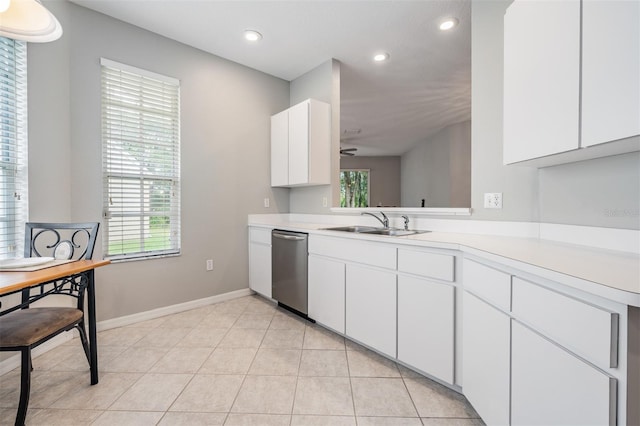 kitchen featuring light tile patterned floors, sink, white cabinets, dishwasher, and kitchen peninsula