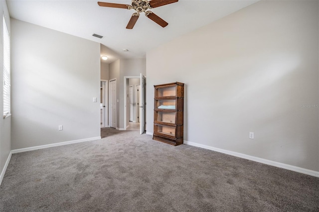 carpeted empty room with ceiling fan and lofted ceiling