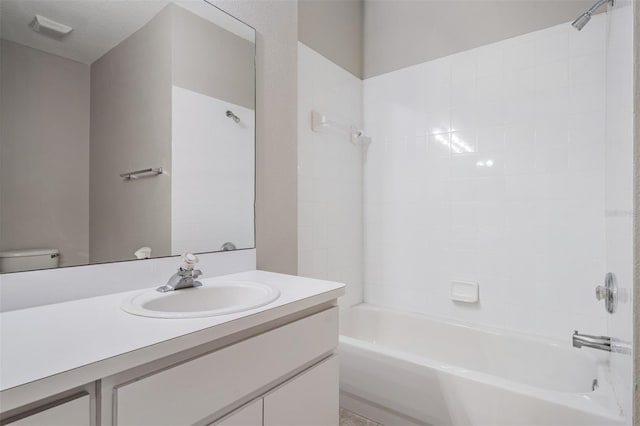 full bathroom with vanity, toilet, and tiled shower / bath combo