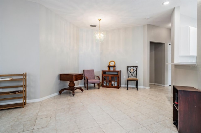 sitting room featuring light tile patterned floors and an inviting chandelier