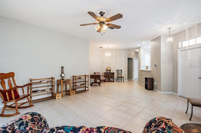 living area with ceiling fan with notable chandelier and light tile patterned floors