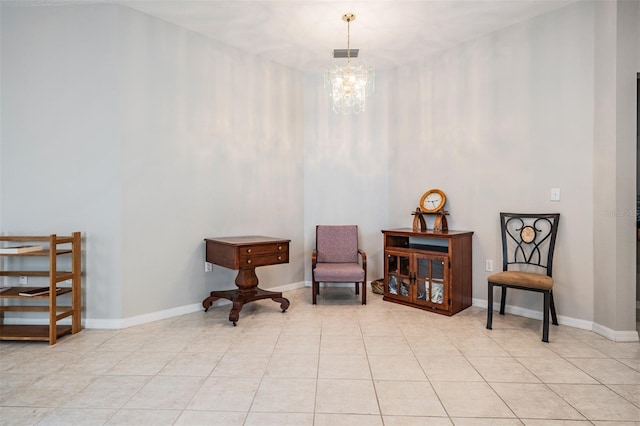 sitting room with a chandelier and light tile patterned flooring