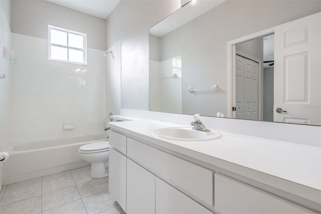 full bathroom with tile patterned flooring, vanity, toilet, and tiled shower / bath