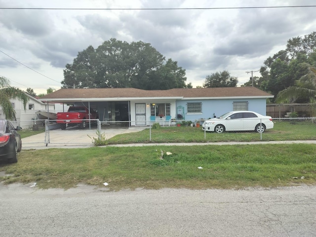 view of front of property with a carport and a front lawn