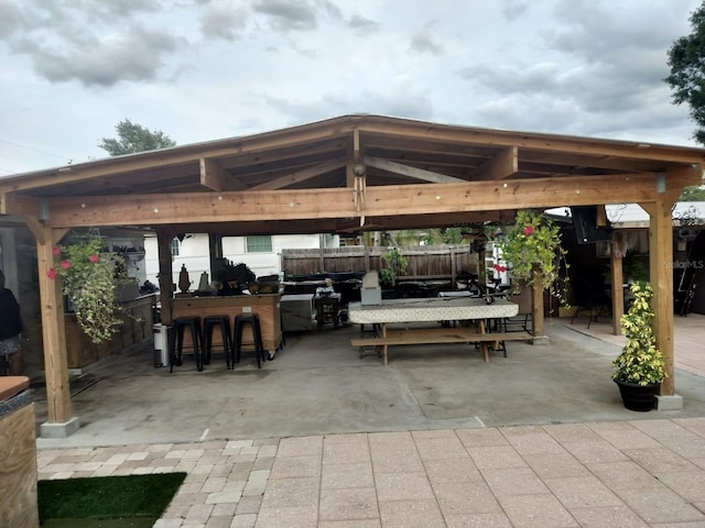 view of terrace with an outdoor bar and a gazebo