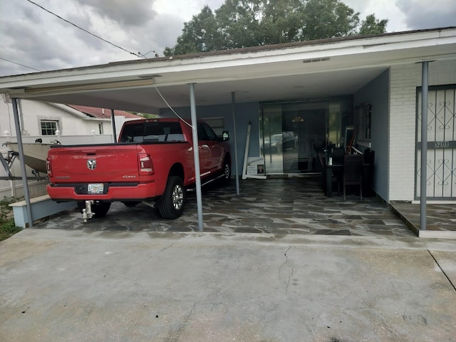 view of vehicle parking with a carport