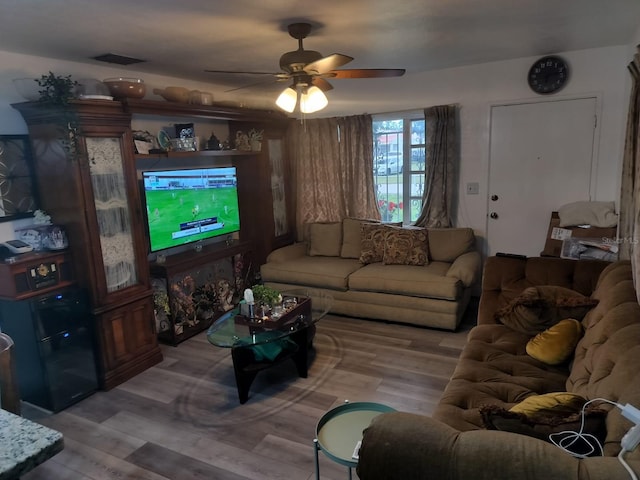 living room featuring light hardwood / wood-style floors and ceiling fan