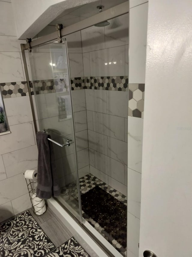 bathroom with tile floors and walk in shower