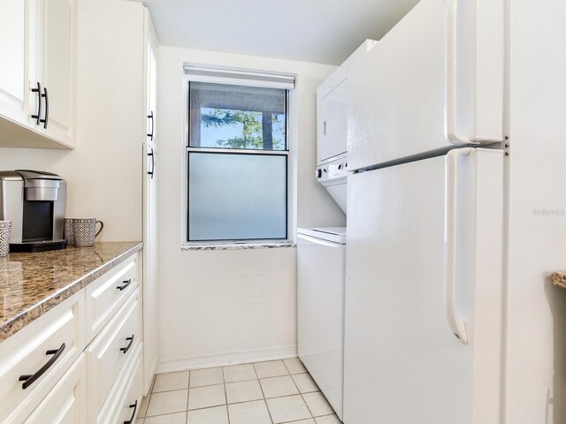 kitchen featuring white cabinetry, white fridge, and light tile patterned floors