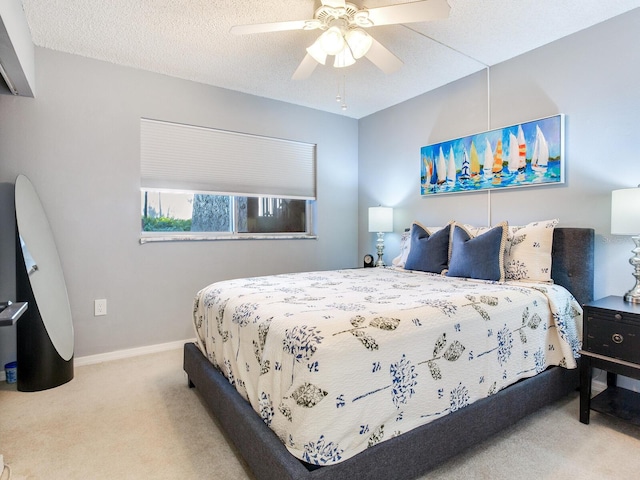 carpeted bedroom with a textured ceiling and ceiling fan