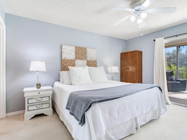 carpeted bedroom with access to exterior, baseboards, a textured ceiling, and a ceiling fan