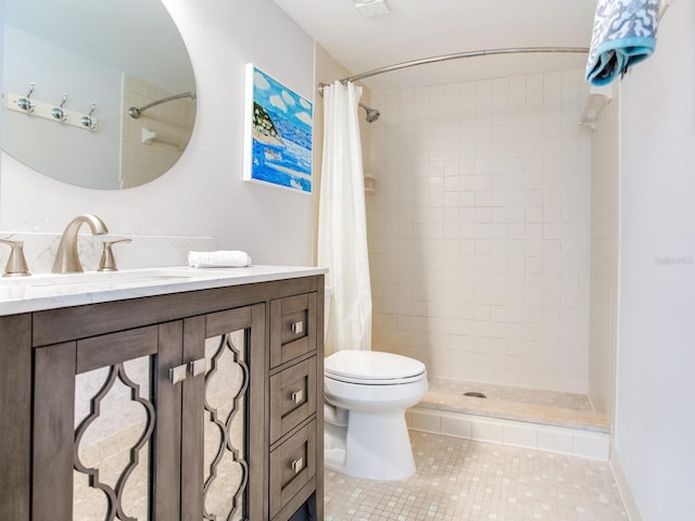 bathroom with tile patterned flooring, toilet, and a tile shower