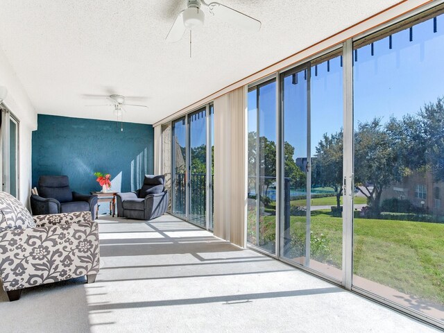 sunroom / solarium featuring ceiling fan