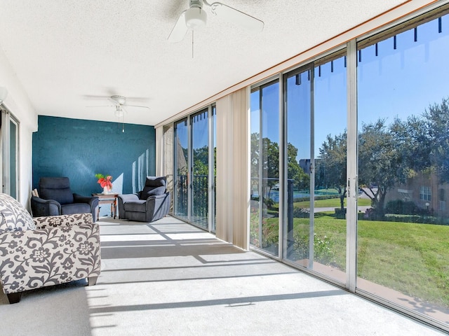 sunroom / solarium featuring ceiling fan