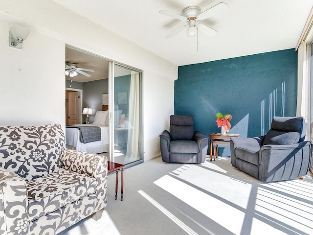 carpeted living room featuring ceiling fan