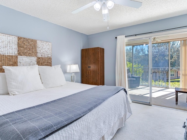 carpeted bedroom with a textured ceiling, access to exterior, and ceiling fan