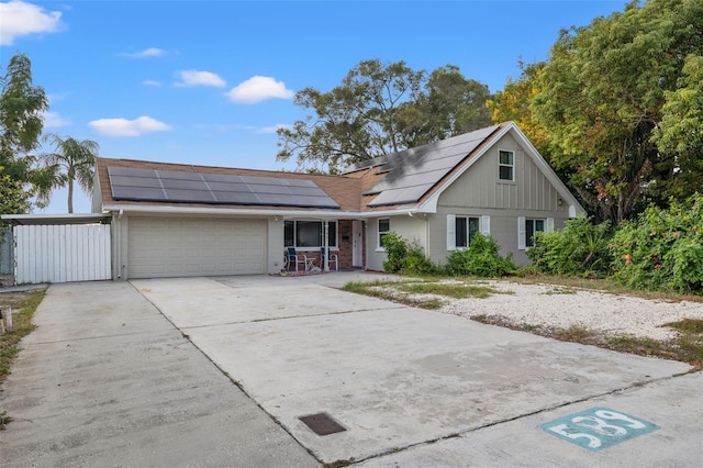 view of front of home featuring solar panels and a garage