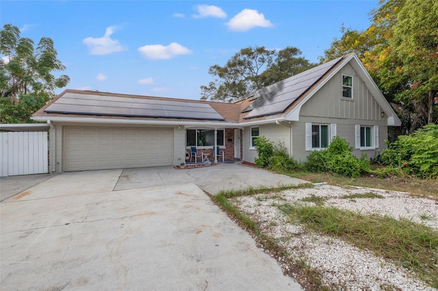 view of front facade with solar panels and a garage