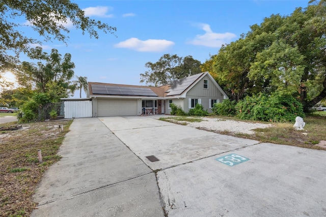 view of front of property with solar panels and a garage