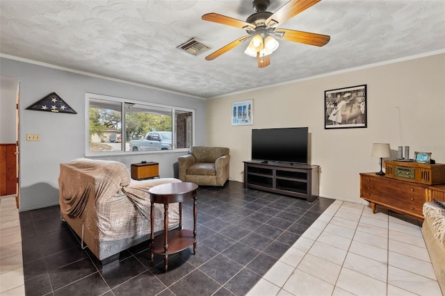 living room with a textured ceiling, tile floors, ceiling fan, and ornamental molding