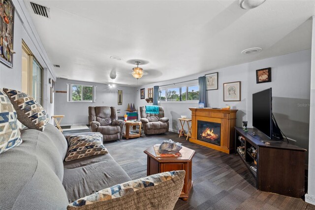 living room with dark carpet and ceiling fan