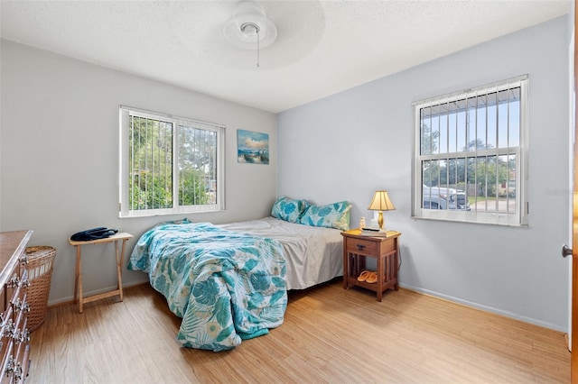 bedroom featuring ceiling fan and light wood-type flooring