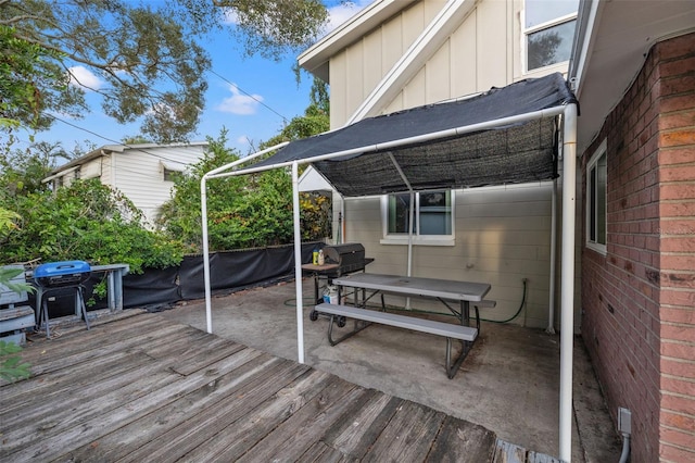 wooden terrace with a patio area