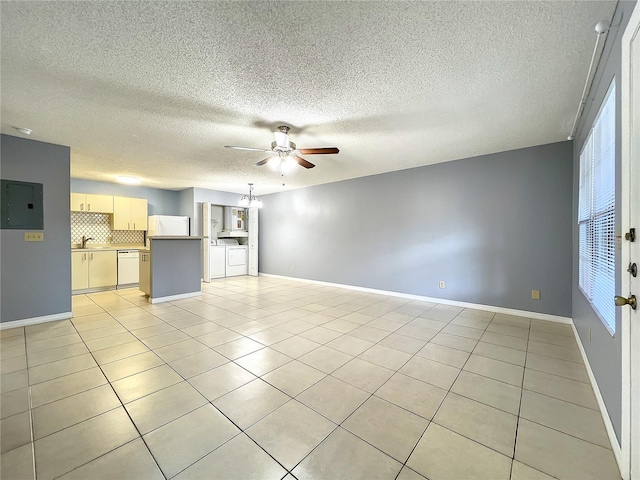 unfurnished room featuring light tile flooring, ceiling fan with notable chandelier, and sink