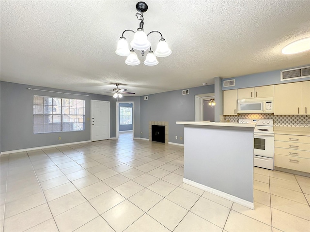 kitchen with white appliances, light tile floors, backsplash, decorative light fixtures, and ceiling fan with notable chandelier