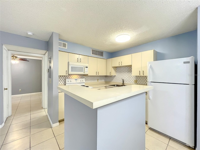 kitchen featuring white appliances, tasteful backsplash, ceiling fan, and light tile flooring