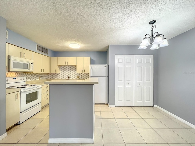 kitchen featuring white appliances, hanging light fixtures, light tile flooring, tasteful backsplash, and a notable chandelier