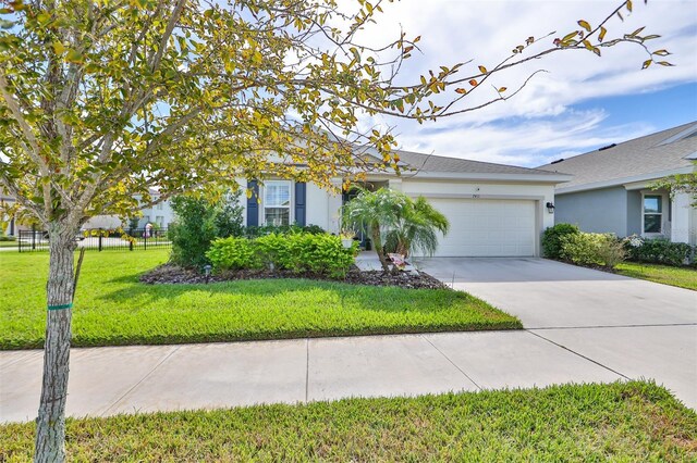 view of front of home featuring a garage and a front lawn