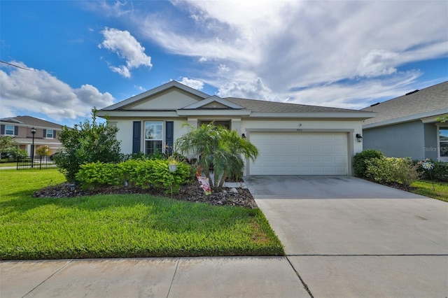 ranch-style house with a garage, driveway, a front lawn, and stucco siding