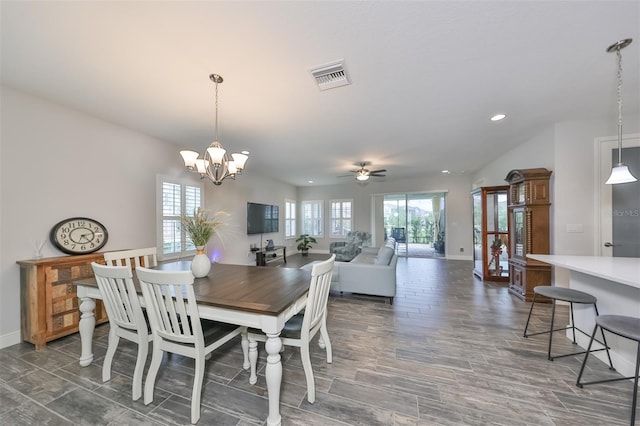 dining space with ceiling fan with notable chandelier and a healthy amount of sunlight