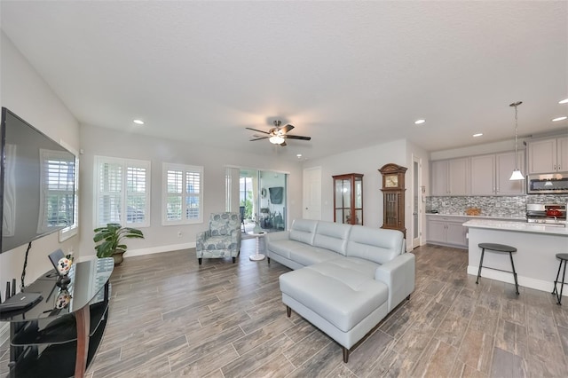 living room featuring light hardwood / wood-style floors and ceiling fan