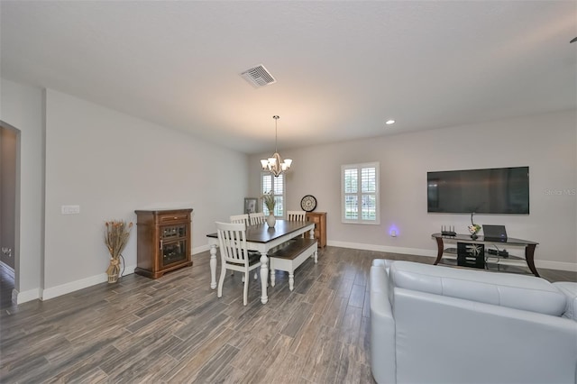 dining space with an inviting chandelier and hardwood / wood-style floors