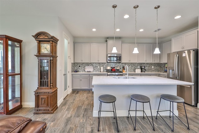 kitchen with tasteful backsplash, appliances with stainless steel finishes, and plenty of natural light