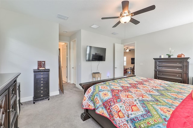 bedroom featuring light carpet and ceiling fan