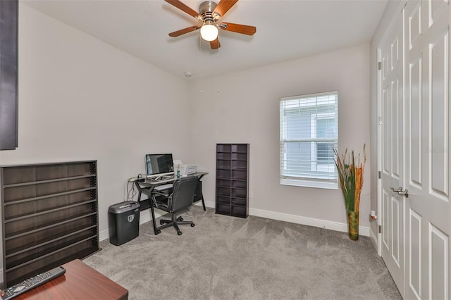 carpeted office space featuring ceiling fan