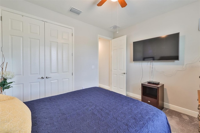 carpeted bedroom featuring ceiling fan and a closet