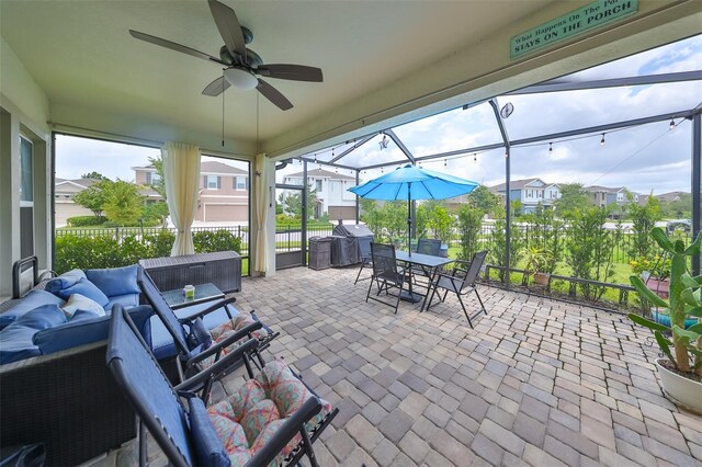 sunroom featuring ceiling fan