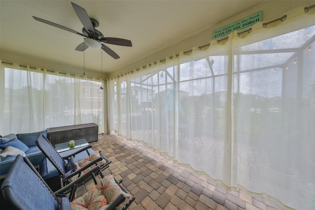 sunroom featuring ceiling fan