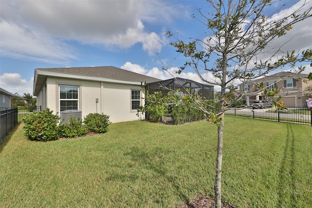 rear view of property featuring a lawn