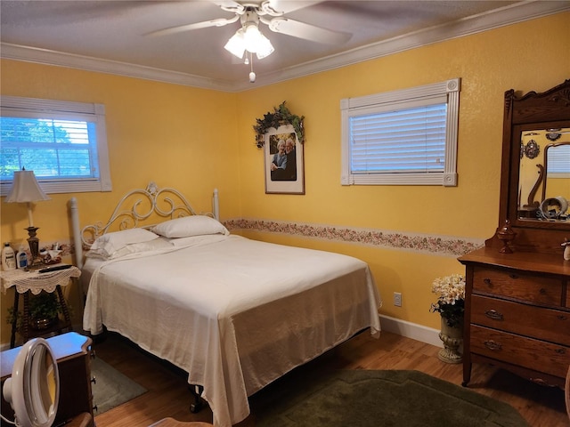 bedroom with ceiling fan, crown molding, and dark wood-type flooring