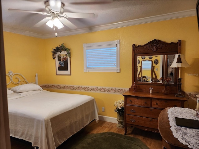 bedroom featuring ceiling fan, ornamental molding, and dark wood-type flooring