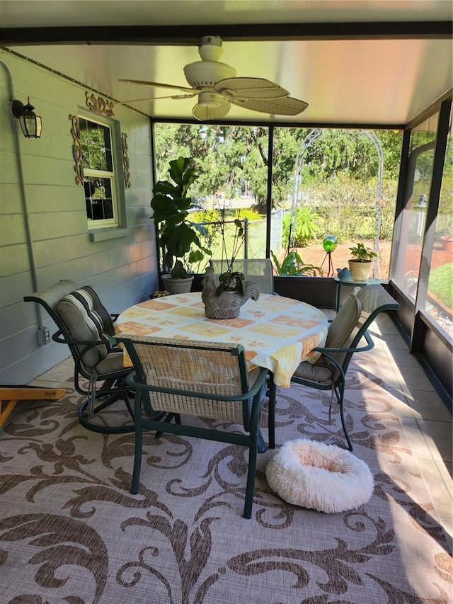 sunroom / solarium with ceiling fan and a healthy amount of sunlight