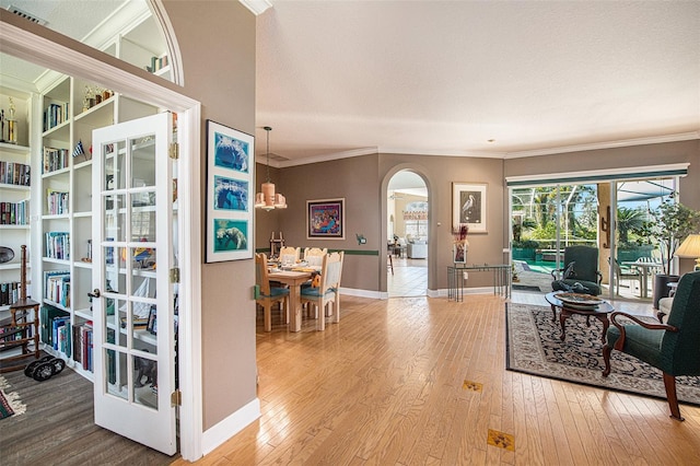 interior space with wood-type flooring and ornamental molding