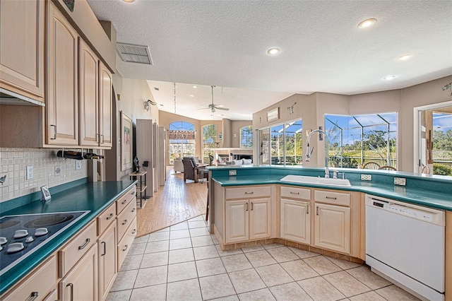 kitchen with ceiling fan, sink, electric stovetop, dishwasher, and light tile patterned flooring