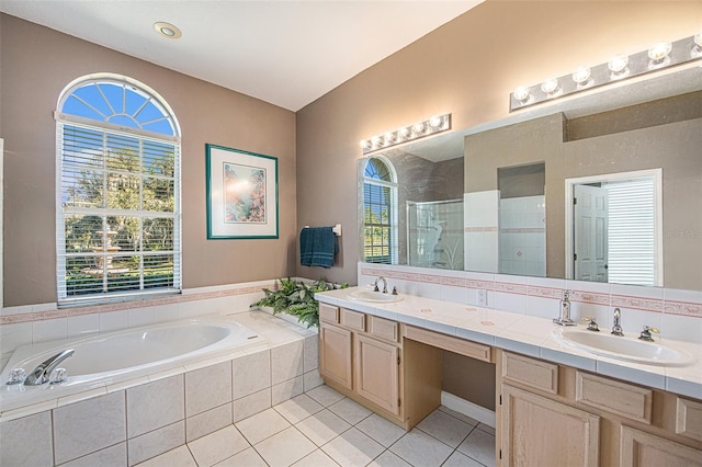 bathroom with tile patterned floors, vanity, and independent shower and bath