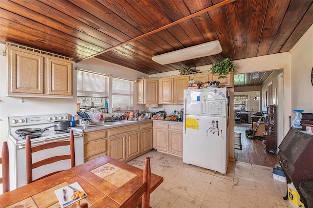 kitchen featuring light brown cabinetry, white refrigerator, range with electric cooktop, and sink